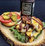 Fully loaded cheeseburger drizzled with SGT. Hart's BBQ Sauce